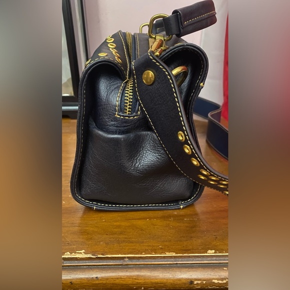 Black leather cross body purse with orange colored medallion on front. - Picture 6 of 14